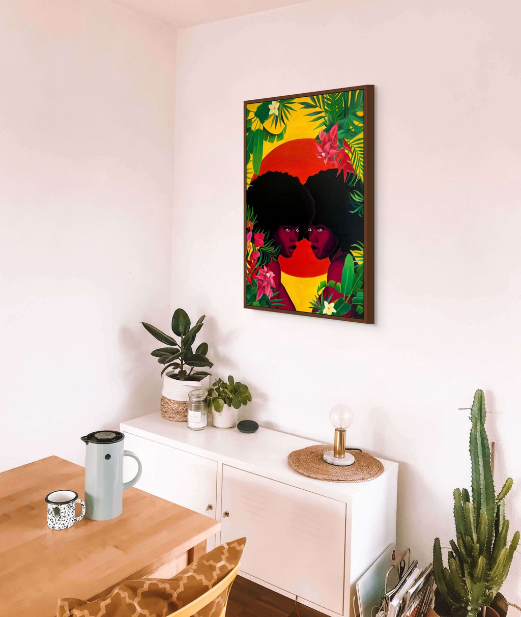 Colorful abstract painting on a wall above a white cabinet with plants and decor.